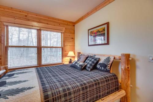 a bedroom with a bed and a large window at Pet-Friendly Garrison Retreat in Garrison