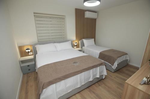 a hotel room with two beds and a window at Dream House Enia 4 in Shkodër