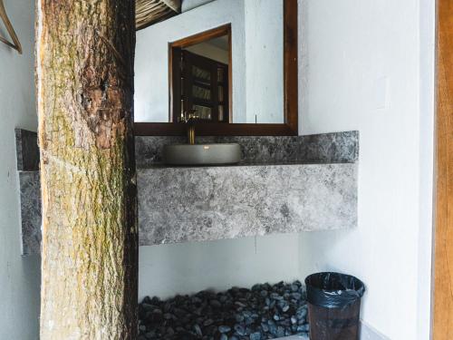 a bathroom with a sink and a mirror at Huku Beach Hostel in Palomino
