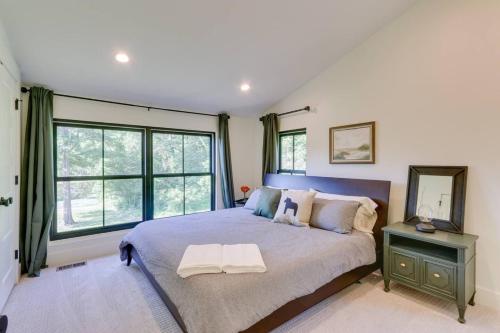 a bedroom with a large bed and a large window at Nature Escape - Pond, Dock, Fire Pit, Trails in Paris