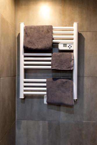 - un porte-serviettes avec 4 serviettes dans la salle de bains dans l'établissement Charmant studio à Saint-Denis - accès direct Paris & Stade de France, à Saint-Denis