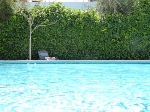 a chair sitting next to a swimming pool at Strip by Check-in Portugal in Albufeira