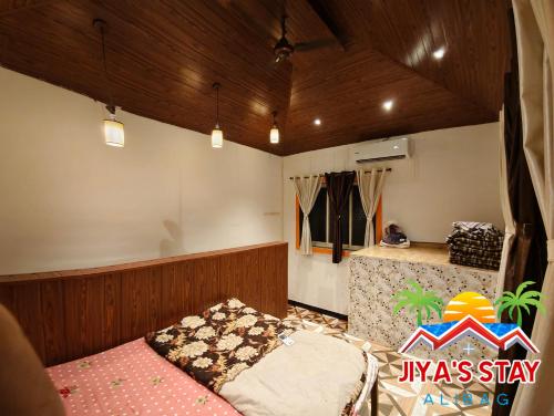 Postel nebo postele na pokoji v ubytování Jiya's Stay