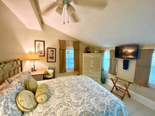 a bedroom with a bed and a ceiling fan at Oceans 11 Steps from the Ocean on Quiet Beach in Saint Augustine Beach