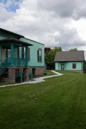 a green house and a house with a yard at The Nautilus at JS Hubbs Guest House in Hammondsport