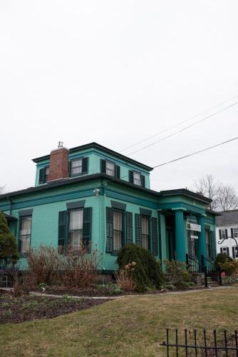 a green house with a brick chimney on top at The Nautilus at JS Hubbs Guest House in Hammondsport