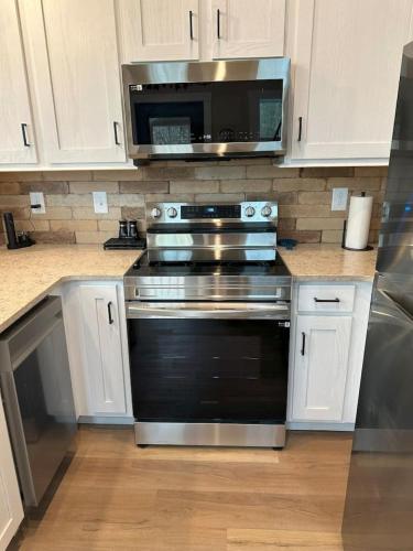 a kitchen with a stove and a microwave at Mount Crumpit 645 - A Different Kind of Getaway in Blairsville