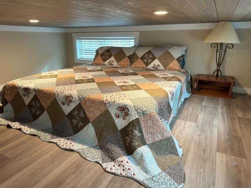 a bedroom with a bed with a quilt on it at Mount Crumpit 645 - A Different Kind of Getaway in Blairsville