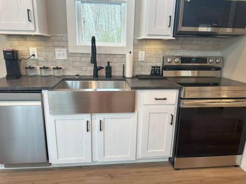 a kitchen with a stainless steel sink and appliances at Mount Crumpit 775 - A Petite Paradise in Blairsville