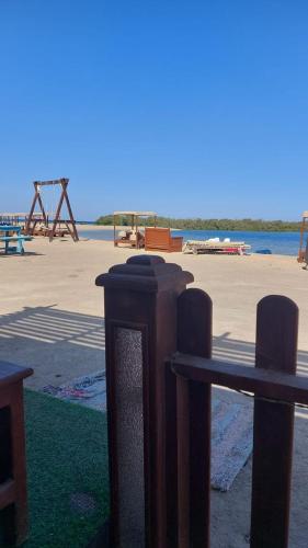 a couple of wooden posts in front of a beach at Nabq Adventure Camp in Nabq