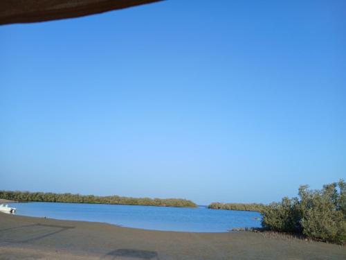 a view of a lake with trees in the distance at Nabq Adventure Camp in Nabq