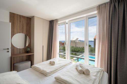 Posteľ alebo postele v izbe v ubytovaní SunAdria Apartments