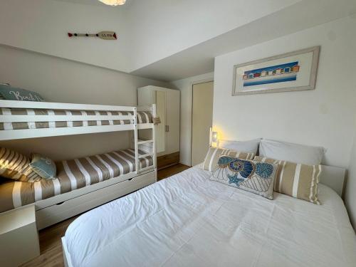 a bedroom with a large white bed in a room at Entre mer & piscine Maison familiale pour 6 in Brétignolles-sur-Mer