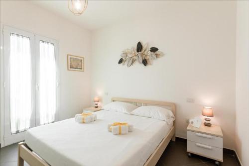 a white bedroom with a large bed with white sheets at GuestHost - Salento Sole e Mare Luxury with Pool in Lendinuso