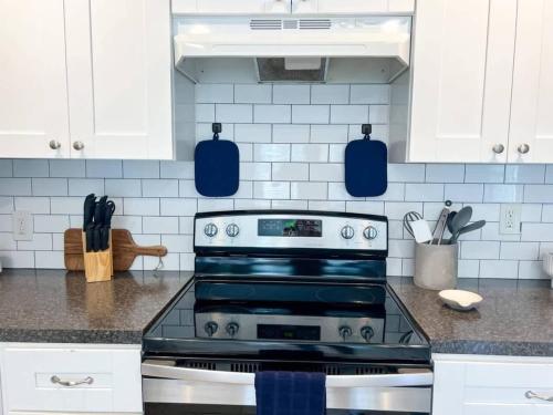 a kitchen with white cabinets and a stove top oven at Entire Home in Dade City! in Dade City