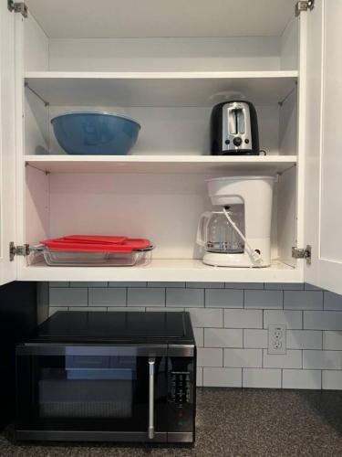 a kitchen with a white cabinet with a microwave at Entire Home in Dade City! in Dade City