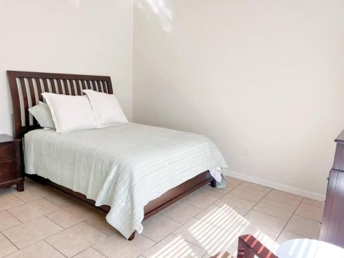 a bedroom with a bed with a white comforter at Entire Home in Dade City! in Dade City