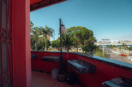 a balcony with benches and a view of a street at Hotel Pousada Zacarias in Anápolis
