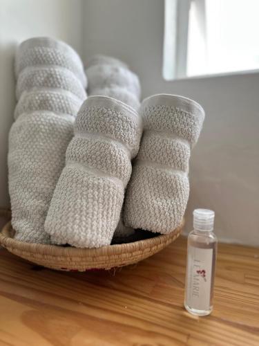 a basket of towels on a table with a bottle of soap at Le MARIE B&B in Cartagena de Indias