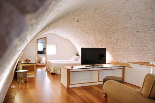 a bedroom with a bed and a tv in a room at Santa Rosa Relais in Noci