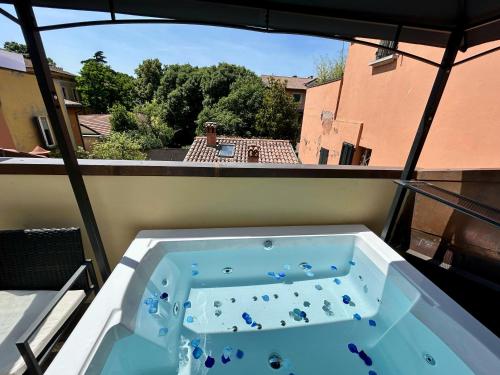 a hot tub on a balcony with a view at BolognaRoomscom - Frassinago Deluxe in Bologna