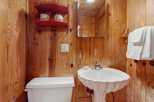 a bathroom with a white sink and a toilet at Beachy Keen in Holden Beach