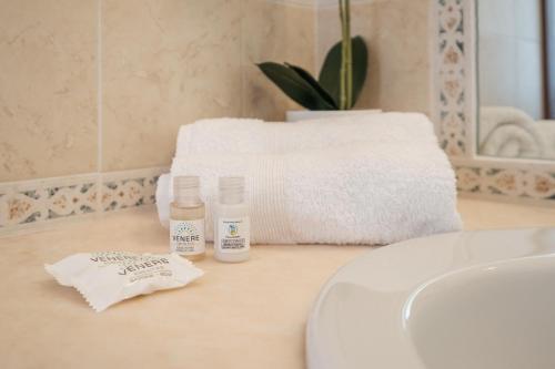 a bathroom counter with two bottles of soap and a sink at Mare e Centro 5 min auto - con Wi-fi, Netflix e A-C in Pula