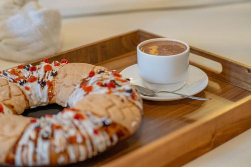 a tray with a cup of coffee and two donuts at La Casona Hotel Boutique in La Paz