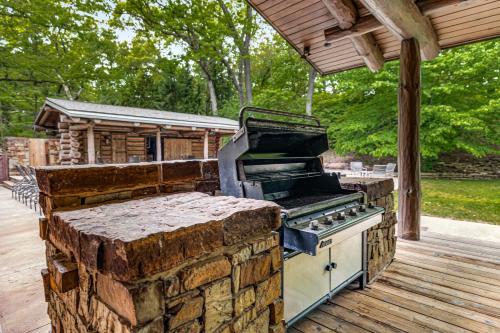 a outdoor grill on a deck with a roof at Wilder Woods in Michiana