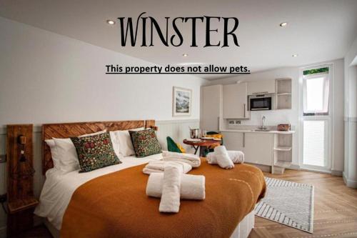 a bedroom with a bed with towels on it at Lake District Woodland Pods - Winster, Bowness-on-Windermere in Winster