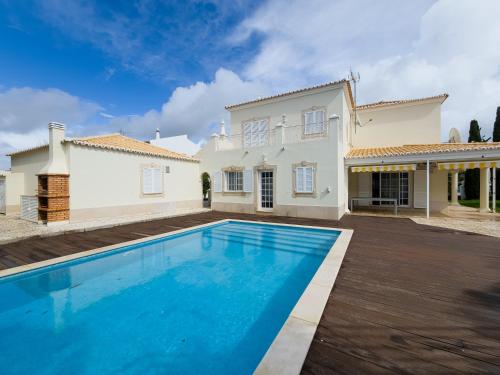 a villa with a swimming pool in front of a house at Casa Marina V4 by YHA in Tavira
