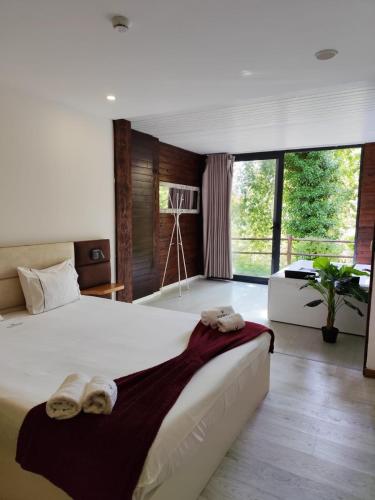 a bedroom with a large bed with towels on it at Dobau casas in Vieira do Minho