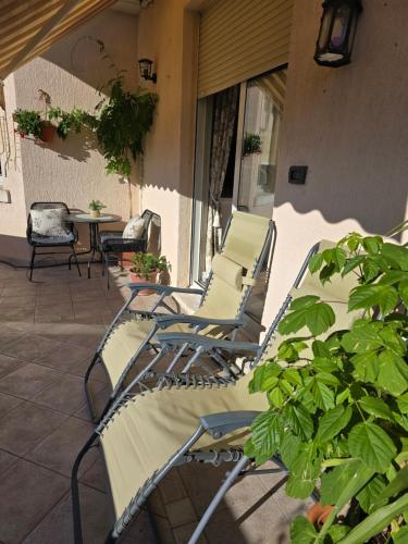 a group of chairs and a table on a patio at Beach apartment Suzy&Demi in Split