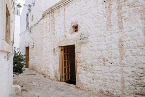 a brick building with a door and a sign on it at Santa Rosa Relais in Noci