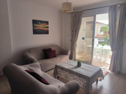 a living room with a couch and a coffee table at 3 Bedroom Affordable Apartment in Oroklini with Communal Pool in Voroklini