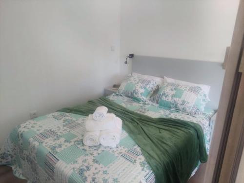 a bed with two rolls of toilet paper on it at Quinta Flor Dos Lagos - Eco Tiny Hause in Torre de Moncorvo