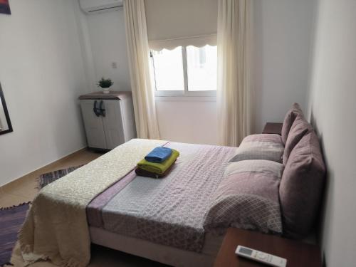 a bedroom with a bed with a yellow object on it at 3 Bedroom Affordable Apartment in Oroklini with Communal Pool in Voroklini
