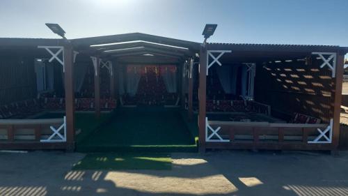 an empty arena with a green field in it at Nabq Adventure Camp in Nabq