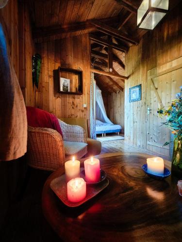 a living room with candles on a table at Hêtre sous le Charme in Saint-Martial-Entraygues