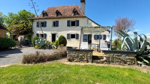 a large white house with a roof at Maison ARDELLI in LʼHôpital-dʼOrion