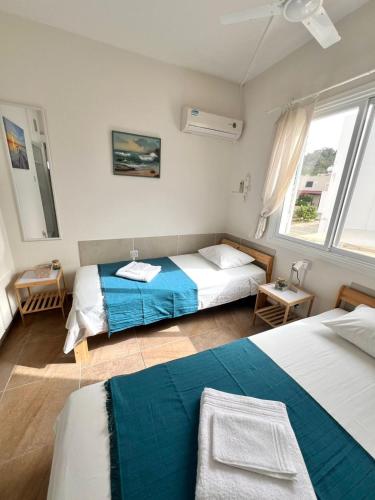 a bedroom with two beds and a couch in it at Green Bay Beach Escape in Protaras