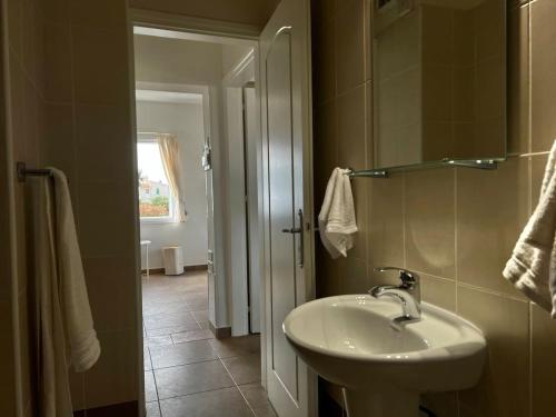a bathroom with a sink and a mirror at Green Bay Beach Escape in Protaras