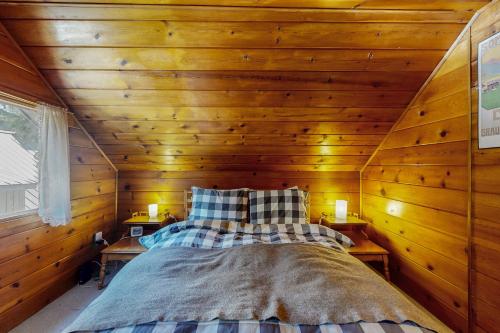 a bedroom with a bed in a wooden wall at Cozy Cabin in Government Camp in Government Camp
