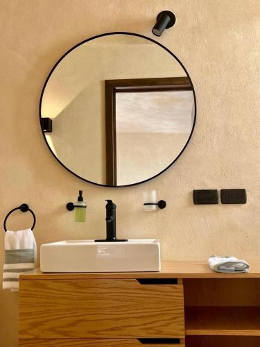 a bathroom with a sink and a mirror on the wall at Casa Yag in Brisas de Zicatela