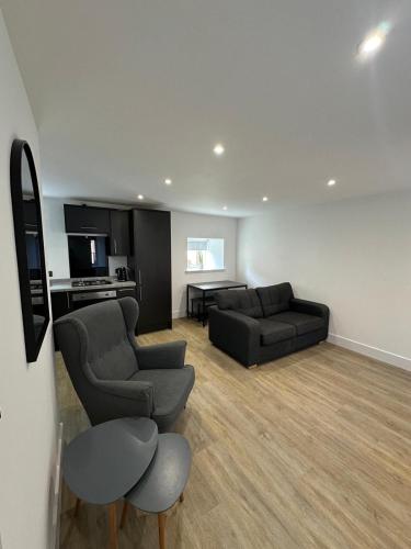 a living room with two couches and a table at St Malcolms Wynd in Angus