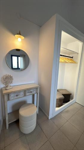 a bathroom with a dressing table and a mirror at Taxiarchis in Symi