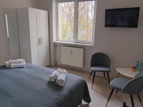 a bedroom with a bed and two towels on it at Dulce Luna in Bucharest