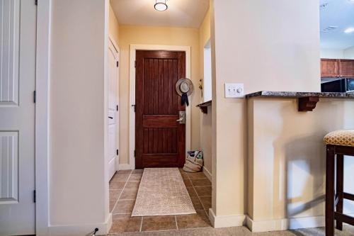 a hallway with a door and a tile floor at 1 BR Top Floor - private balcony & views 5304 in Saint Augustine