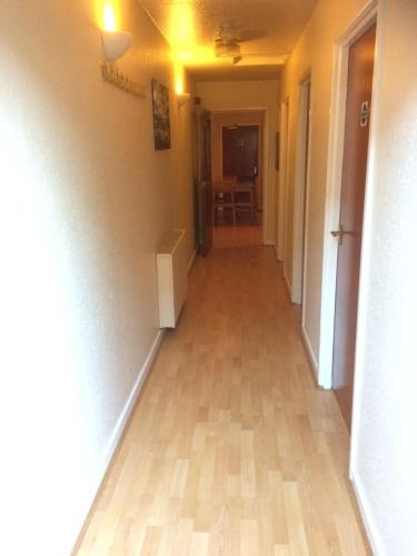 an empty hallway with a wooden floor in a house at 1 bedroom spacious flat in Dewsbury