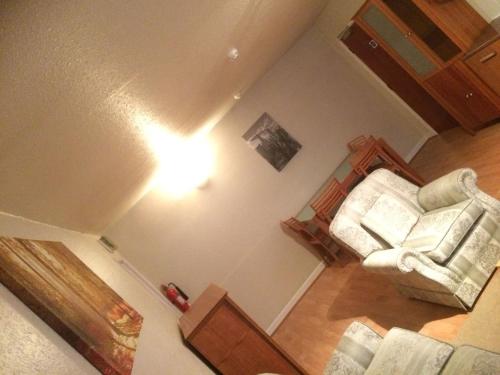 a living room with a couch and a chair at 1 bedroom spacious flat in Dewsbury